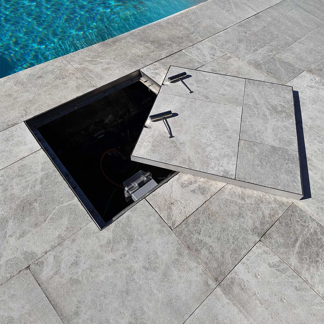HIDE stainless steel Manhole Cover with grey tile inlay over swimjet pool system.