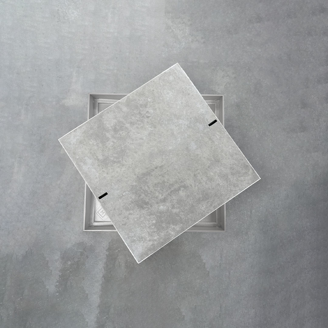 HIDE Concrete Polymer Skimmer Cover shown with Concrete infill lifted open, revealing the hidden frame beneath for clean, non-conductive access.