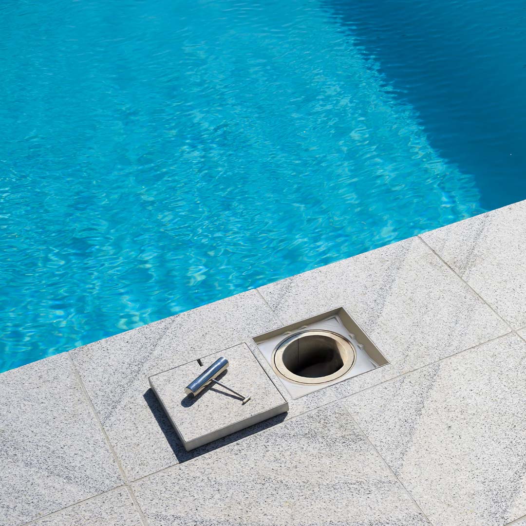 HIDE non conductive Ash Full Polymer Access Cover with tile inlay installed next to swimming pool.