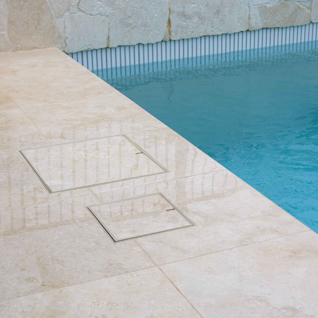 HIDE non conductive Bone Full Polymer Skimmer Lid and Access Cover sitting flush with surrounding swimming pool tiles.