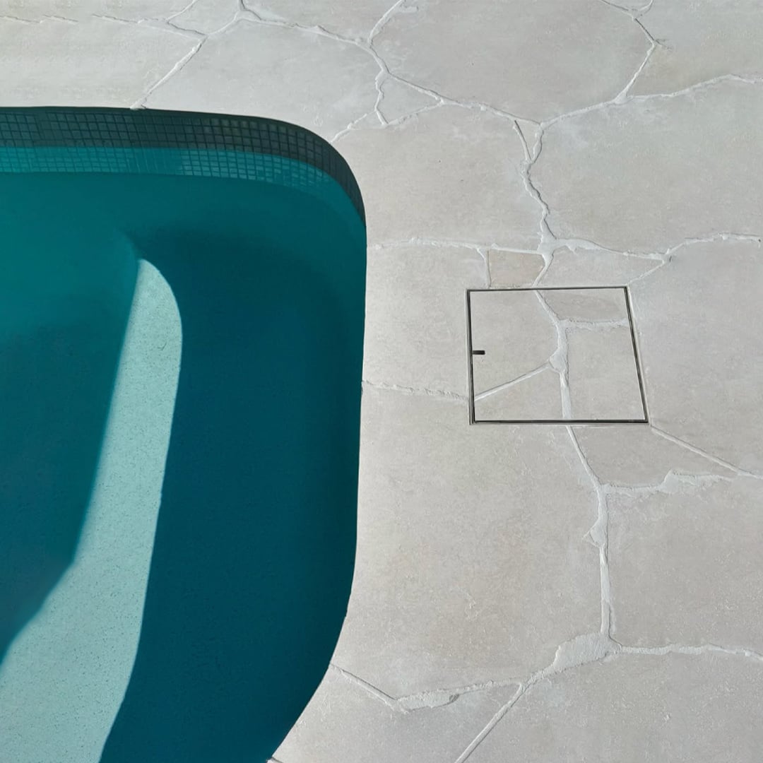 HIDE Skimmer Lid with crazy pave inlay next to swimming pool